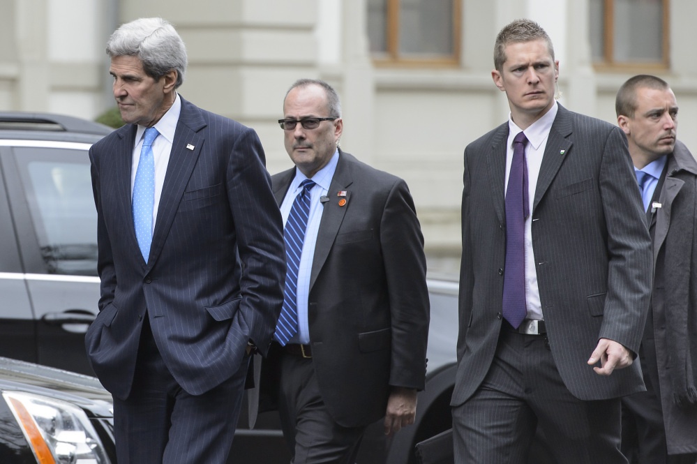 U.S. Secretary of State John Kerry, left, takes a walk during a break of a new round of talks on the Iranian nuclear program in Lausanne, Switzerland on Sunday.