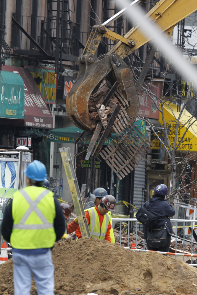 Debris are cleaned up from the site of a building collapse in the East Village neighborhood of New York, on Friday. A body was found Sunday in the rubble left behind by an apparent gas explosion.