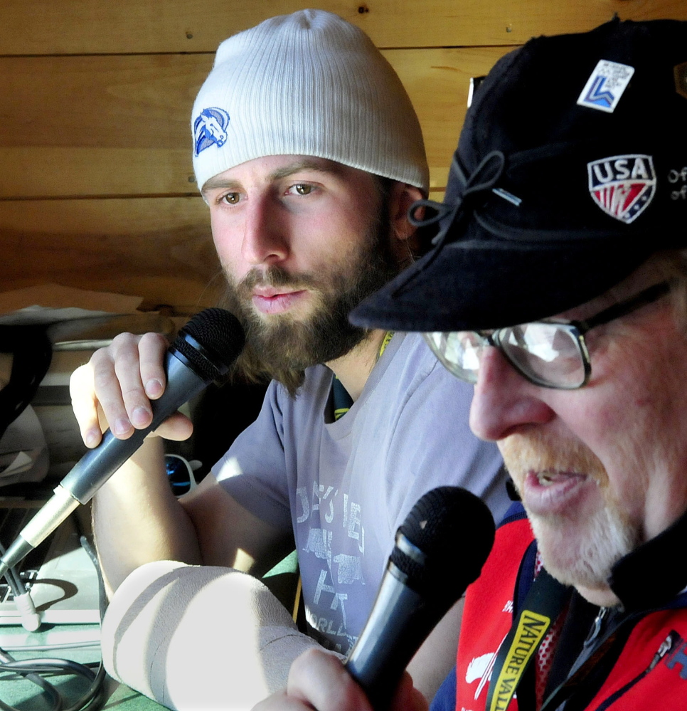 Race commentator Craig Marshall, left, speaks to the crowd at the finish line during the slalom races at the U.S. Alpine Championships on Sunday at Sugarloaf. At right is race announcer Peter Graves.