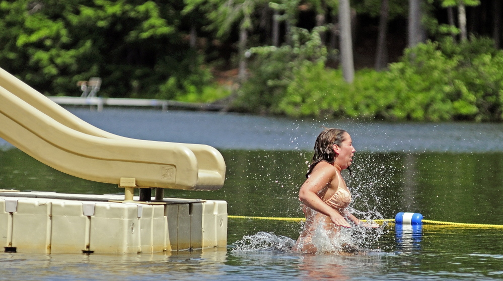 Kristin Lamontagne hits the water of Three Cornered Pond after coming off the slide at Bicentennial Nature Park in Augusta last summer. The city park is currently open to Augusta residents only, but there is a proposal to open the park to non-residents as well.