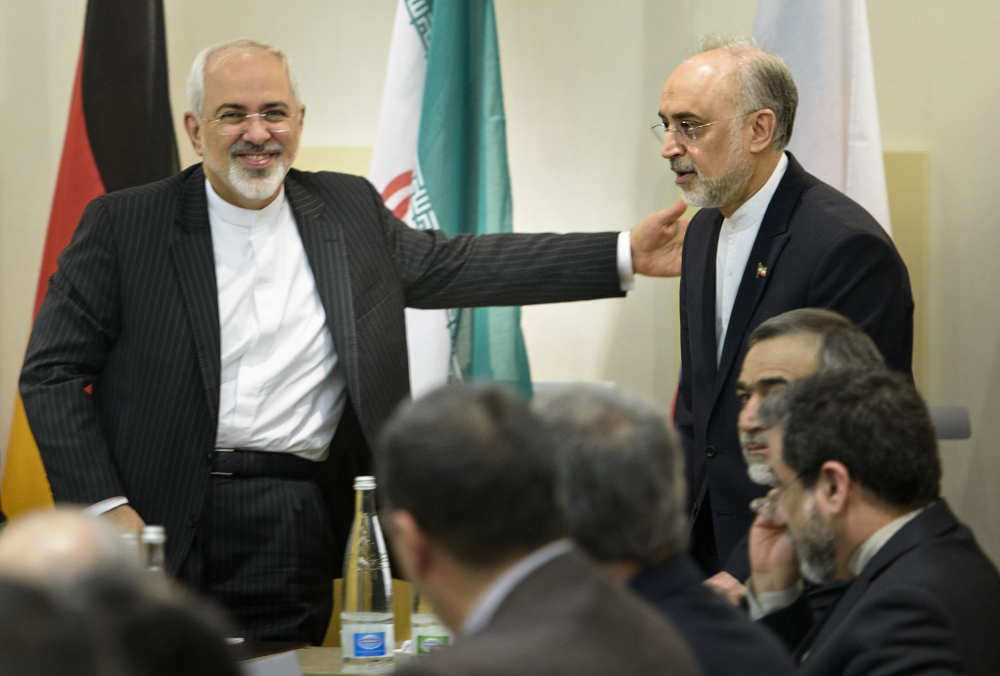 Iranian Foreign Minister Javad Zarif, lefts, greets Ali Akbar Salehi, head of Iran’s Atomic Energy Organization, upon the latter’s arrival for a meeting on Iran’s nuclear program Tuesday with officials from Britain, China, France, Germany, Russia, the United States and the European Union. Diplomats meeting in Lausanne, Switzerland, worked past their deadline to reach consensus on the outline of deal.
