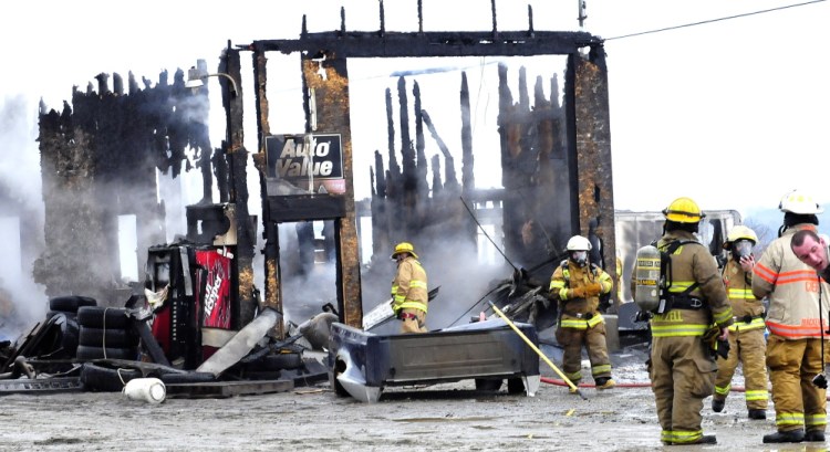 Firefighters extinguish fire that destroyed Ray’s Auto garage in North Belgrade on Monday.