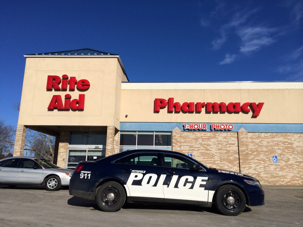 A police cruiser from nearby Pittsfield stands outside the Rite Aid Pharmacy in Newport after a robbery there Tuesday afternoon.