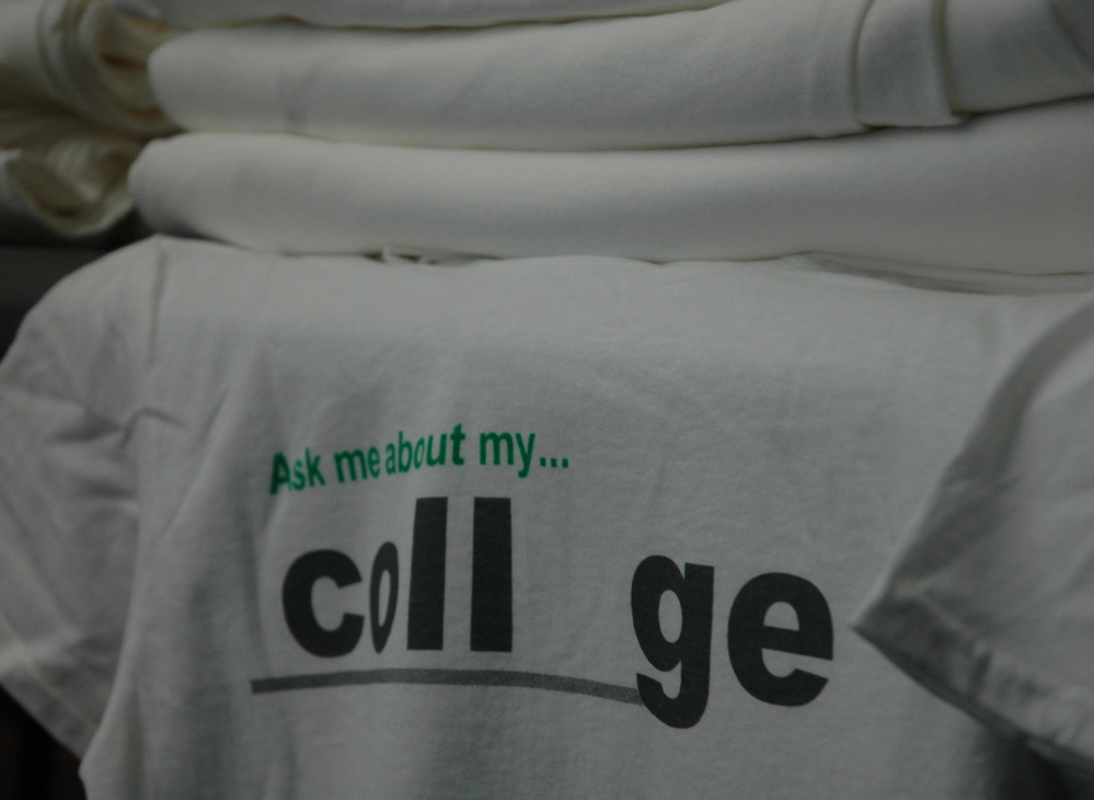 T-shirts given to the students by the Maine College Circle as part of a program to get families thinking about college as a goal early in a student’s academic career lie stacked on Tuesday at Skowhegan Area High School.