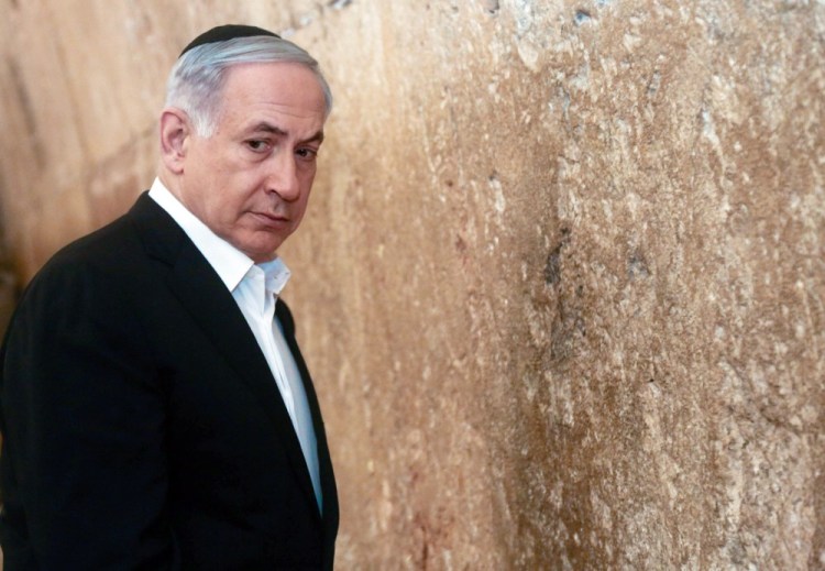 Israeli Prime Minister Benjamin Netanyahu looks on before praying at the Western Wall, the holiest site where Jews can pray, in Jerusalem’s Old City, Saturday.