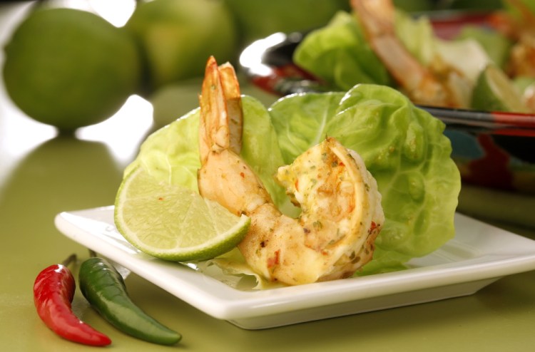 Shrimp are marinated in piri piri sauce, then quickly sauteed before being served in lettuce leaves with more of the spicy sauce. Photos by Michael Tercha/TNS