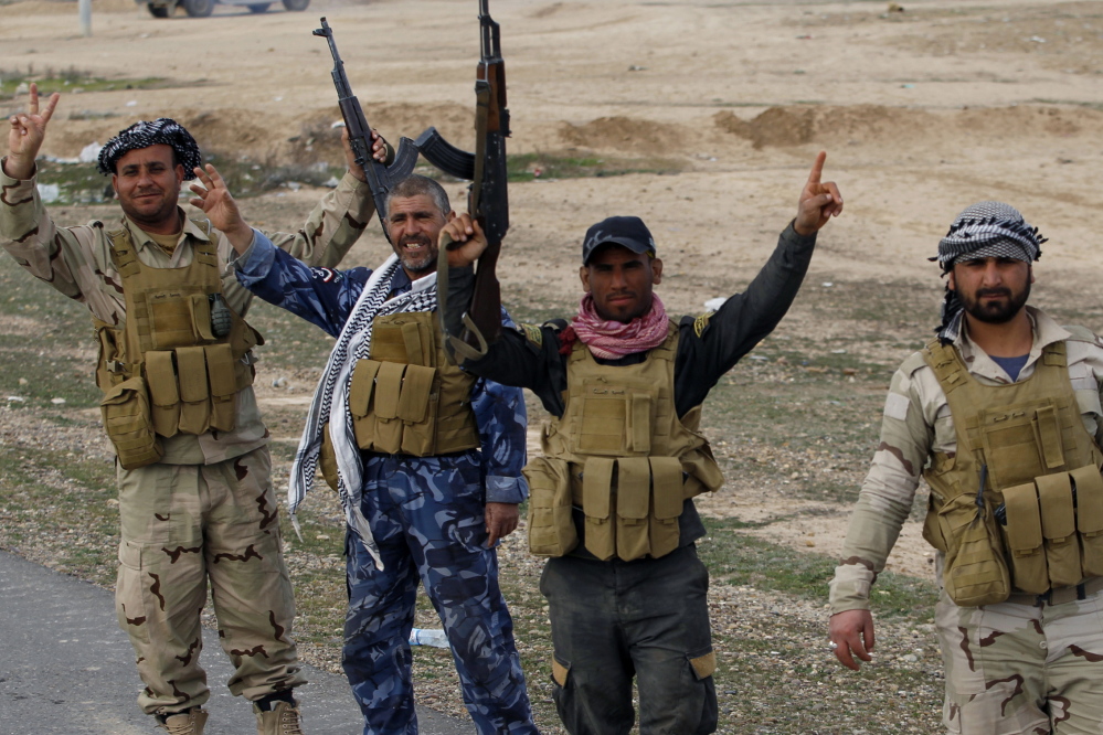 Members of the Iraqi security forces and Shiite fighters celebrate Tuesday after taking control of the town of Hamrin from Islamist State militants, in the Salahuddin province. But the battles for Tikrit and Mosul could morph into an urban war of attrition with many more casualties.