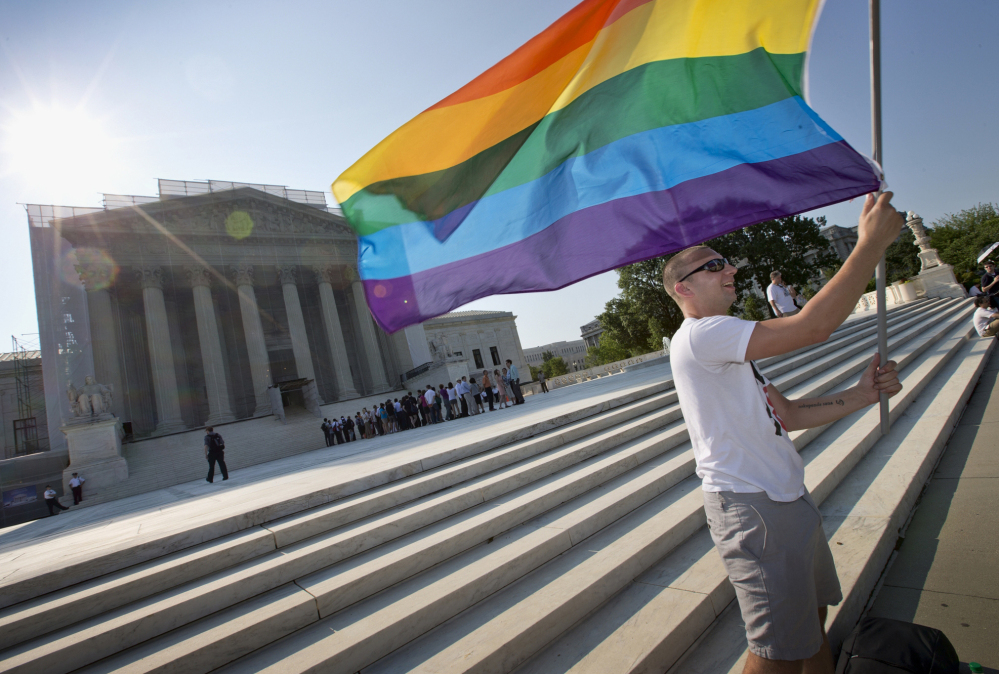 Vin Testa of Washington waves a rainbow flag in support of gay rights outside the Supreme Court in Washington in June 2013. 