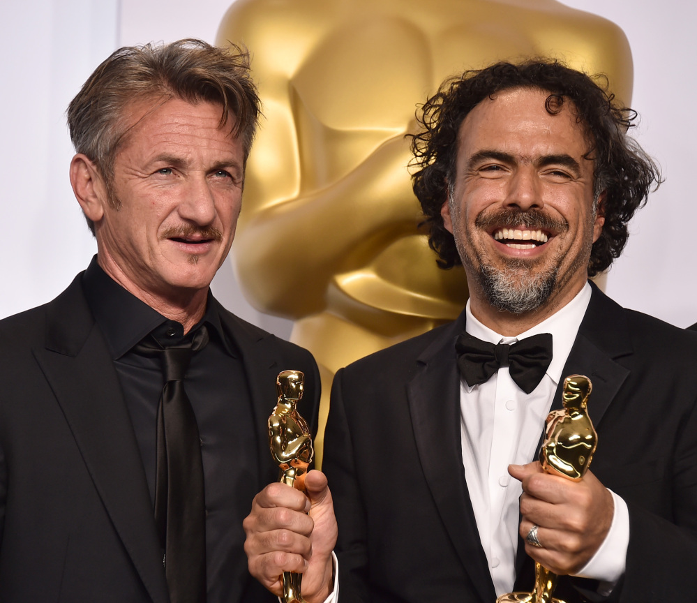 Oscar presenter Sean Penn, left, poses with filmmaker Alejandro Iñárritu, who won multiple awards including best original screenplay, best director and best picture for “Birdman.”