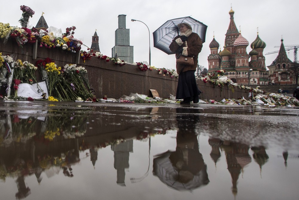 An elderly woman passes the place where Boris Nemtsov, a charismatic Russian opposition leader and sharp critic of President Vladimir Putin, was gunned down on Feb. 27 near the Kremlin in Moscow.