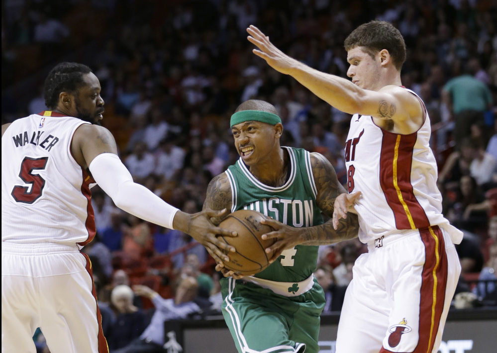 Celtics guard Isaiah Thomas drives past Miami Heat guard Henry Walker (5) and guard Tyler Johnson, right, during the first half of Monday night’s game in Miami. Thomas scored 25 points in the Celtics’ 100-90 win.