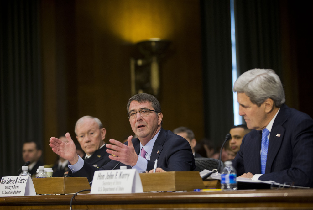 Defense Secretary Ash Carter, center, flanked by Secretary of State John Kerry, right, and Joint Chief Chairman General Martin Dempsey, testifies on Capitol Hill in Washington, Wednesday, March 11, 2015, before the Senate Foreign Relation Committee. Three of America's top national security officials face questions on Capitol Hill about new war powers being drafted to fight Islamic State militants, Iran's sphere of influence and hotspots across the Mideast. (AP Photo/Pablo Martinez Monsivais)