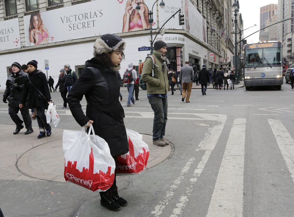 A shopper carries shopping bags in New York last month. Retail sales fell 0.6 percent in February, the government said Thursday, as consumers were slow to boost spending despite robust hiring in the past year and sharply lower gas prices.