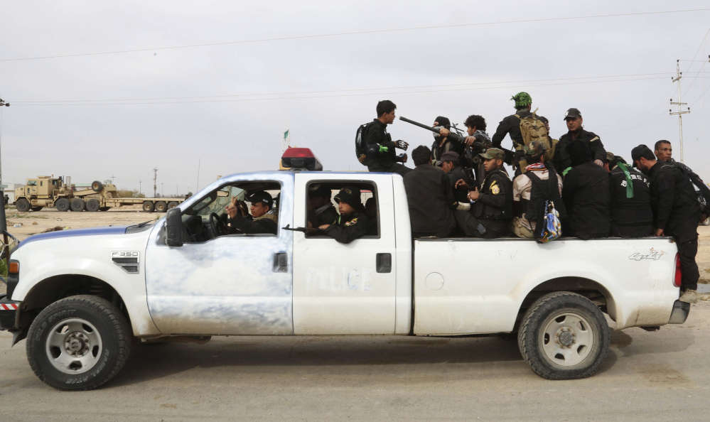 Shiite militiamen at Camp Speicher, the front line in Tikrit, 80 miles north Baghdad, Thursday. Rockets and mortars echoed across Tikrit as Iraqi security forces clashed with Islamic State militants.