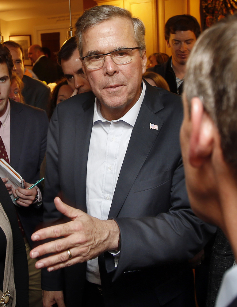 Former Florida Gov. Jeb Bush speaks with New Hampshire residents at a packed house party Friday in Dover, N.H.