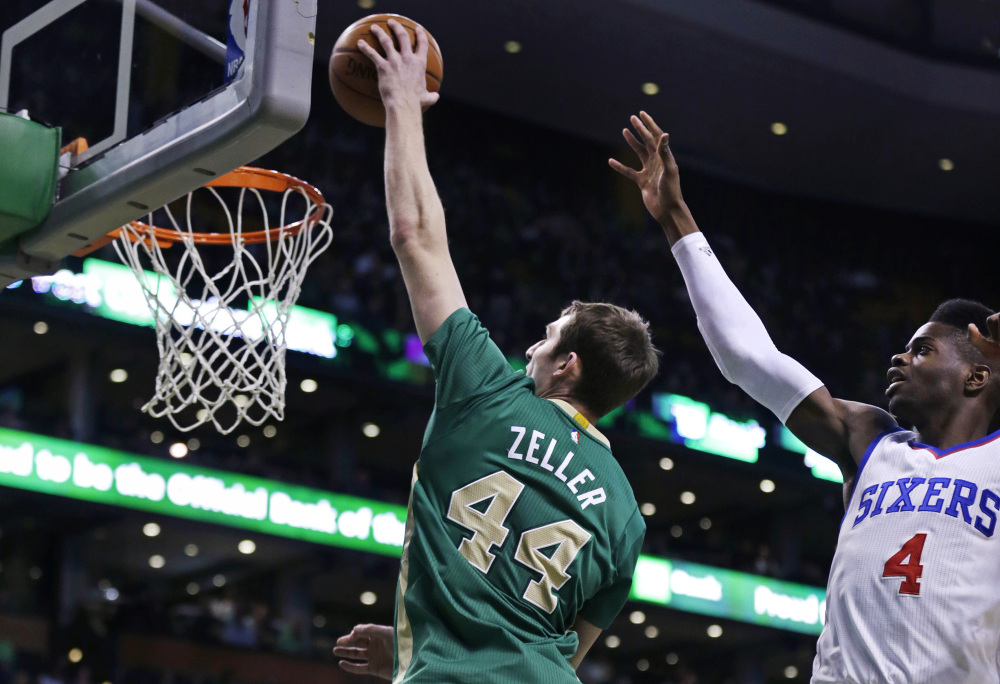 Boston Celtics center Tyler Zeller drives past Philadelphia 76ers center Nerlens Noel for a dunk during the first quarter of Monday night’s game in Boston. Zeller finished the game with a career-high 26 points as the Celtics won easily.