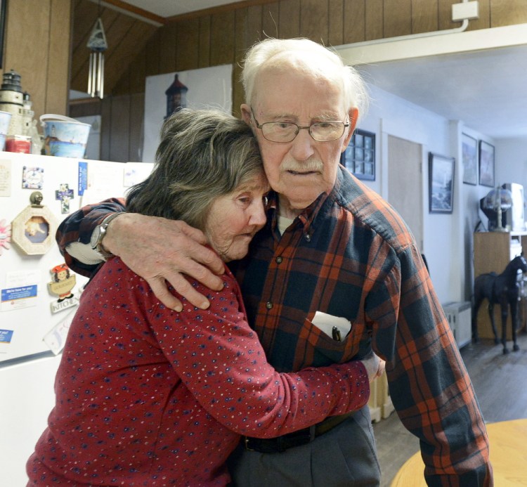 Real L’Heureux embraces Grace Harakles in the kitchen of her Sanford home Tuesday. On Wednesday, he returned to the locked memory-care facility where he has been living.