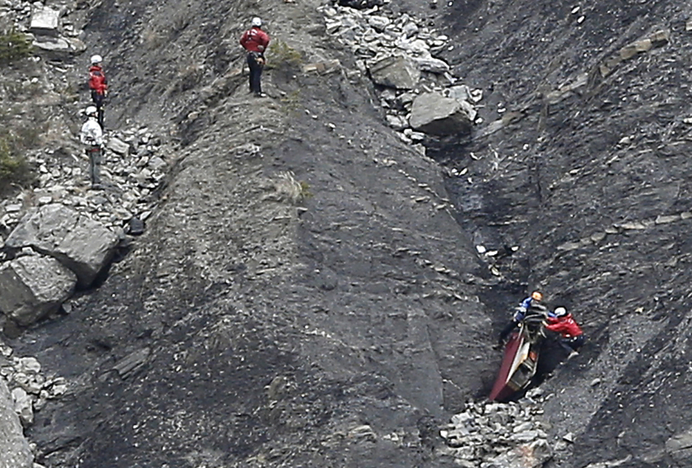 Rescue workers work on debris at the plane crash site near Seyne-les-Alpes, France, on Wednesday, where a Germanwings jetliner crashed Tuesday in the French Alps.