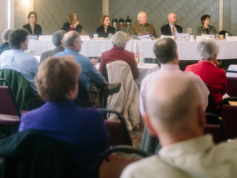 Nearly 200 people pack the Brunswick Golf Club on Wednesday to hear testimony and later speak for or against the proposed Downeaster layover facility that some fear would pose threats to groundwater. Others said pollution from cars poses the greater threat.