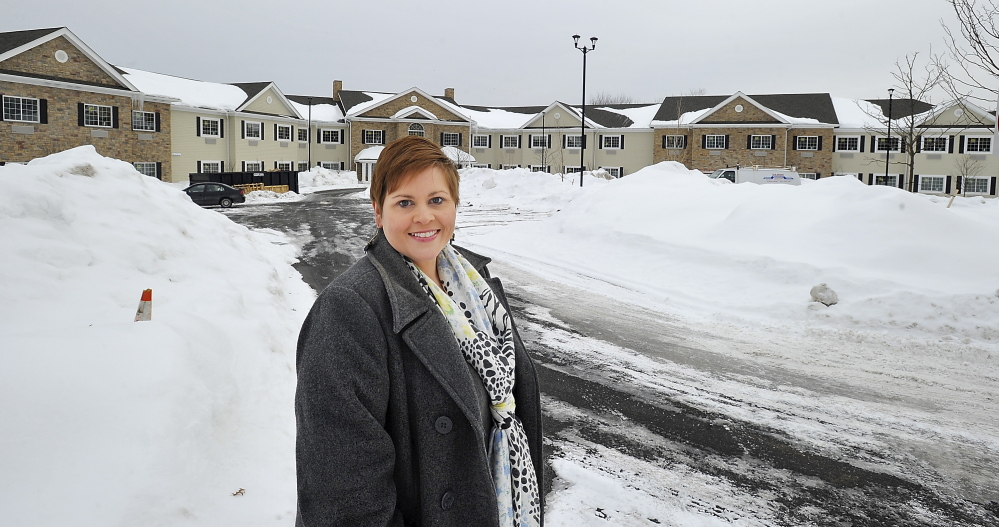 Bellavita executive director Melissa Craig stands near the senior apartment complex set to open this spring in Scarborough. The first Maine property of the nation’s largest senior housing developer will charge rents starting at $4,200 per month.