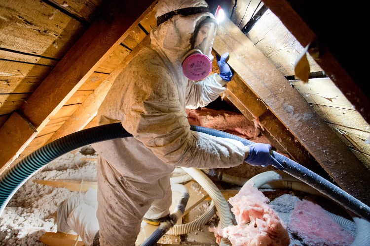A worker from Evergreen Home Performance blows cellulose insulation into the attic of Jim Johnson's house in Portland on Wednesday. Johnson got the work done with the help of a $2,000 rebate program from Efficiency Maine. The state Public Utilities Commission voted Tuesday to cap the Efficiency Maine Trust's funding at $22 million for the fiscal year beginning in July 2016, rather than the $60 million the Legislature apparently intended.
