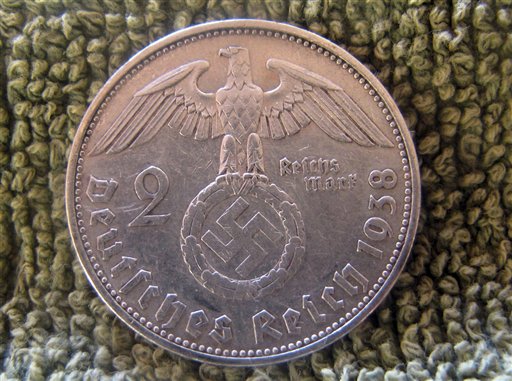 A German coin from 1938 found in the remains of a house built inside Teyu Cuare Park, near San Ignacio in the northeastern province of Misiones, Argentina. Archaeologists say ruined buildings in an Argentine nature reserve might have been planned as a World War II-era hideout for top Nazi officers. (AP Photo/University of Buenos Aires Urban Archeology Center)