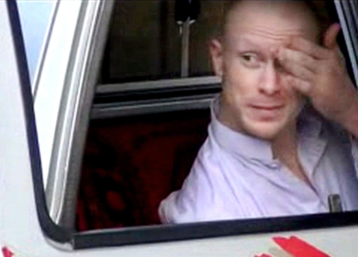 Sgt. Bowe Bergdahl sits in a vehicle guarded by the Taliban in eastern Afghanistan in this image taken from video obtained from Voice Of Jihad Website. The Associated Press