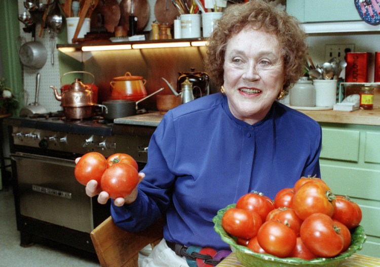 Chef and author Julia Child holds tomatoes in the kitchen at her home in Cambridge, Mass on Aug. 13, 1992. More than a decade after her death, the foundation she created finally is launching a culinary award named in her honor. The Julia Child Award, which will be named annually, will be presented to someone who has improved how Americans think about food and cooking. The first winner will be announced in August 2015 and the award will be presented in October.