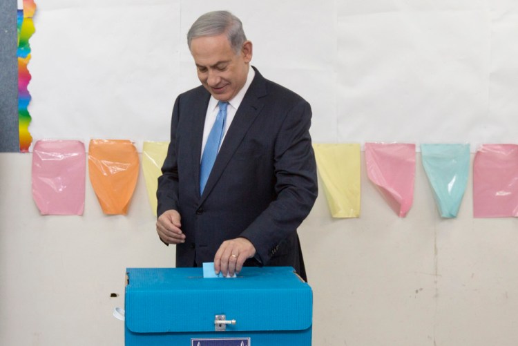Israeli Prime Minister Benjamin Netanyahu casts his vote during Israel's parliamentary elections in Jerusalem, Tuesday. The Associated Press