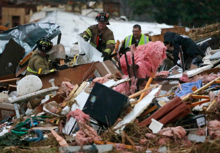 First responders work to free a man from a pile of rubble after a round of severe weather hit a trailer park in Sand Springs, Okla. on Wednesday.