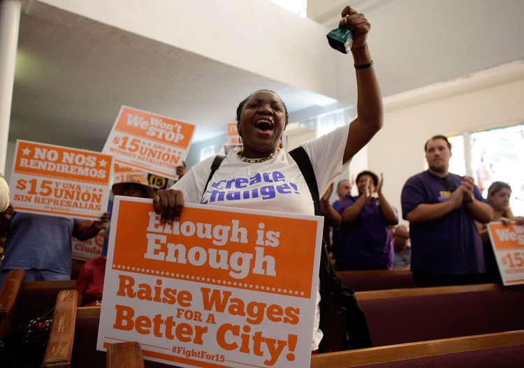 Activist Paulette Darow rings a cow bell Wednesday as protesters listen to speeches at the Greater Bethel AME Church in Miami in support of raising the minimum wage to $15 an hour as part of an expanding national movement.
The Associated Press