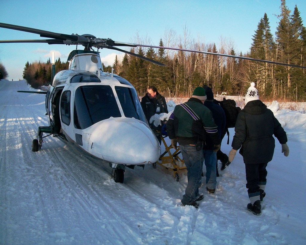 Rescue workers load Laurie Clarke into a LifeFlight helicopter. 