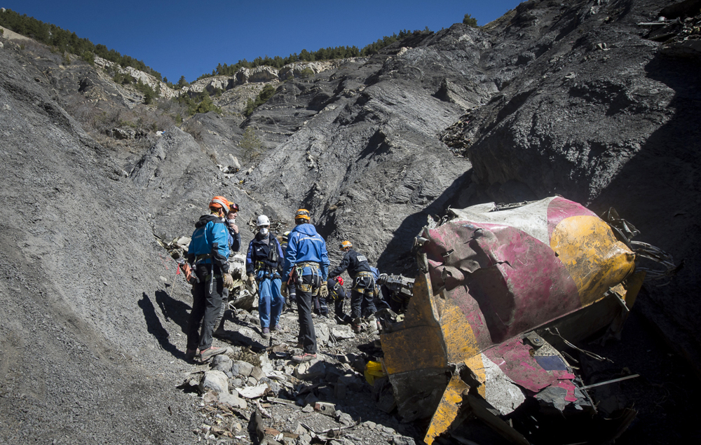 In this photo taken on Tuesday and provided by the French Interior Ministry, French emergency rescue services work among debris of the Germanwings passenger jet at the crash site near Seyne-les-Alpes, France.