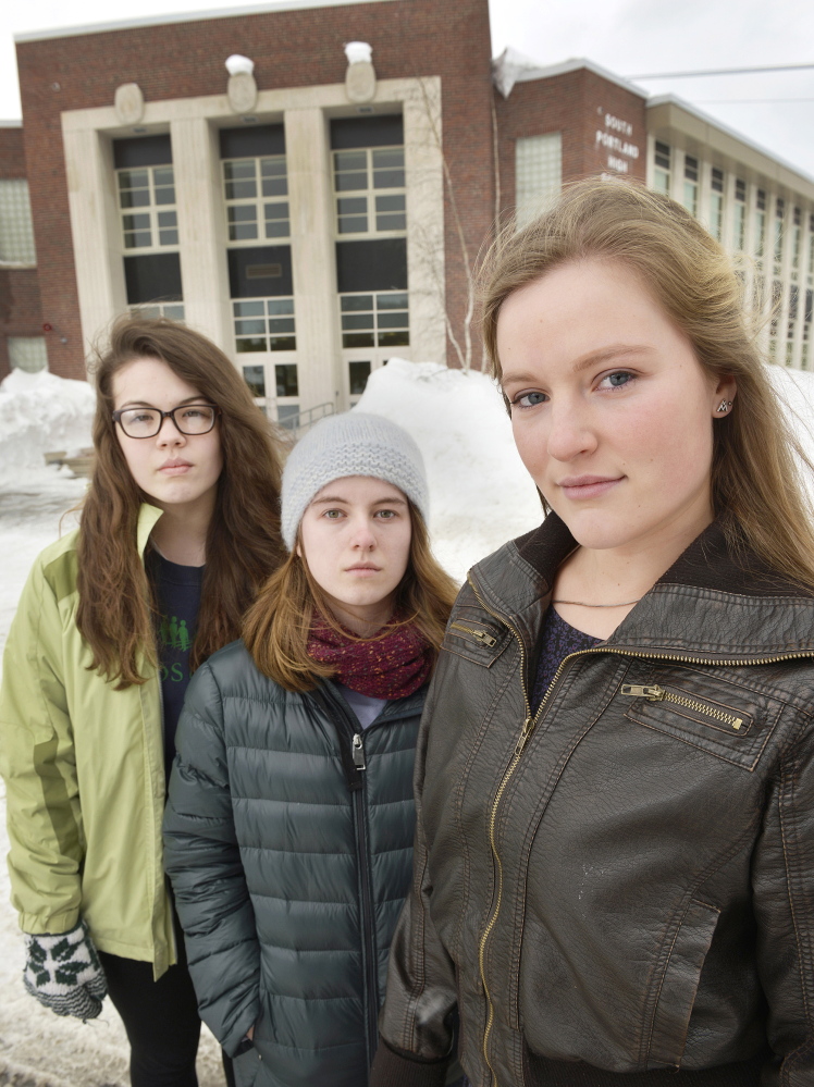 South Portland senior class President Lily SanGiovanni, right, joined by two of her supporters, Morrigan Turner, left, and Gaby Ferrell, stand in front of the high school where she has led an effort to let students and teachers know they don’t have to say the Pledge of Allegiance.