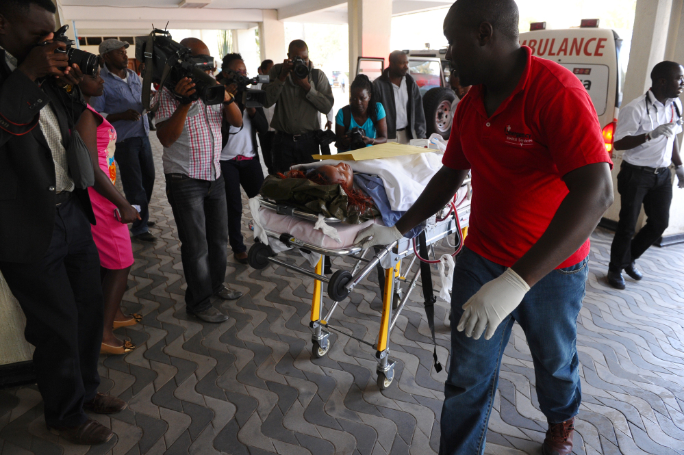 Medics help an injured person airlifted to Kenyatta National Hospital in Nairobi, Kenya, on Thursday after an attack at Garissa University College in northeastern Kenya.