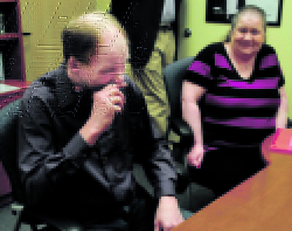 Michael Fernald, of Clinton, and his wife, Diane, cry after Michael received hearing aids that allowed him to hear his wife’s voice for the first time since he was injured in a car accident two years ago.