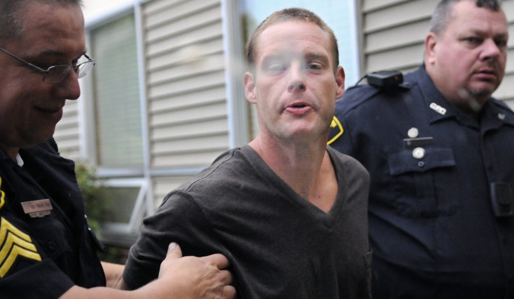Jesse Mansir, 31, spits after being arrested by Gardiner police in this file photo. On Friday, he was sentenced to more than four years in prison after robbing a pharmacy.