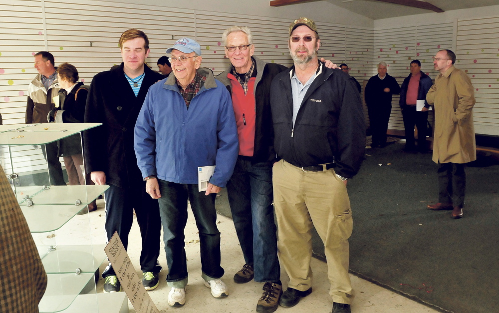 Several generations of Weeks family owned and operated the former A.L. Weeks & Son business in Waterville that was auctioned off on Thursday. From left are Christopher, Harland, Maynard and Chris Weeks. At right is auctioneer Mike Carey.