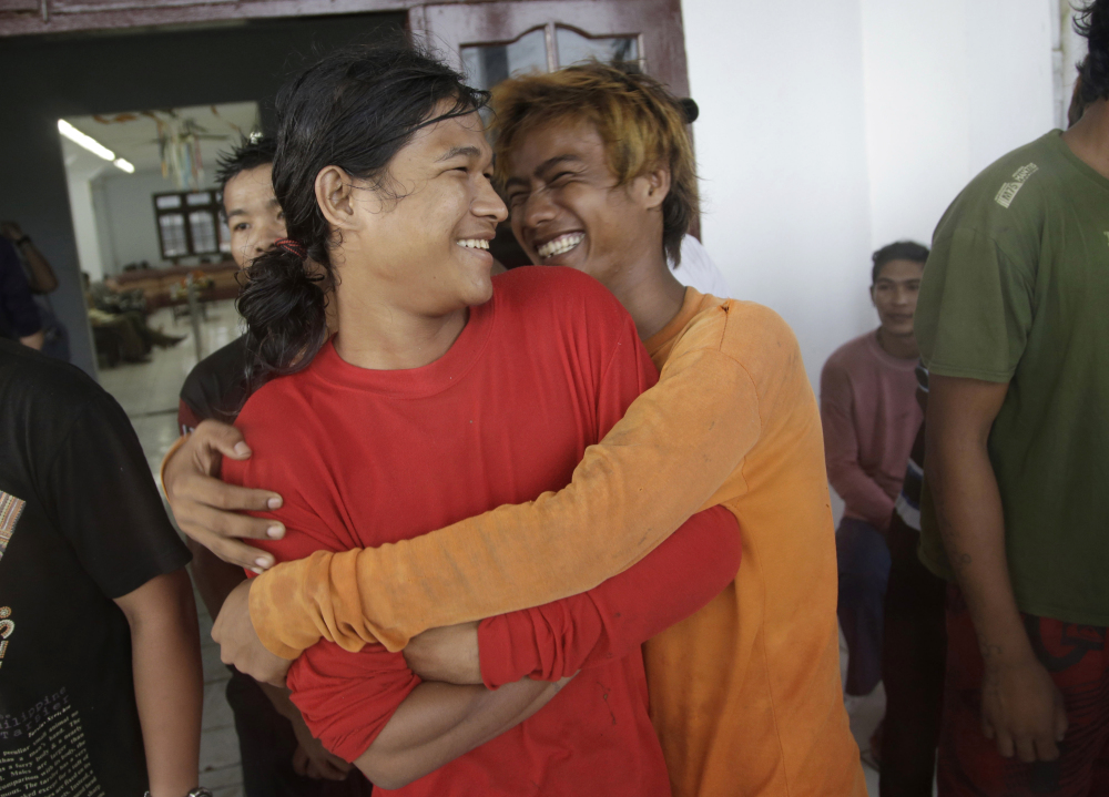 Burmese fishermen hug each other as they wait for their departure to leave the compound of Pusaka Benjina Resources fishing company in Benjina, Aru Islands, Indonesia on Friday. Hundreds of foreign fishermen rushed at the chance to be rescued from the isolated island where an Associated Press report revealed slavery runs rampant in the industry. Indonesian officials investigating abuses offered to take them out of concern for the men’s safety.