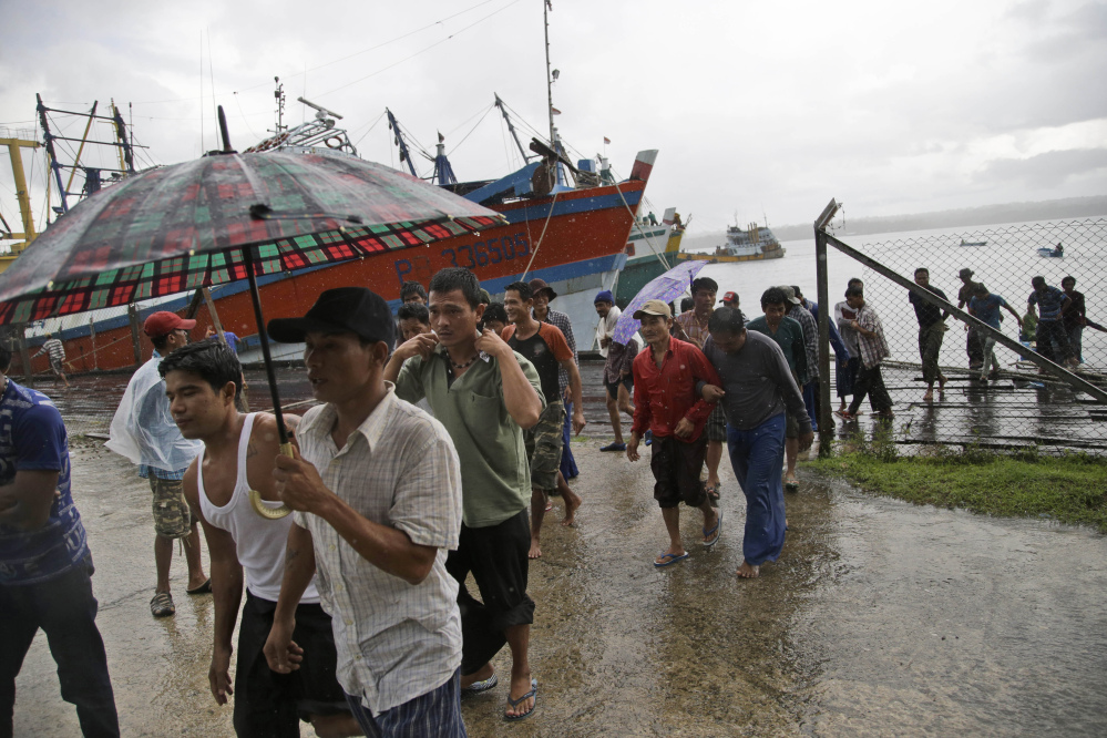 Burmese fishermen arrive at the compound of Pusaka Benjina Resources to report themselves for departure to leave the fishing company in Benjina, Aru Islands, Indonesia.