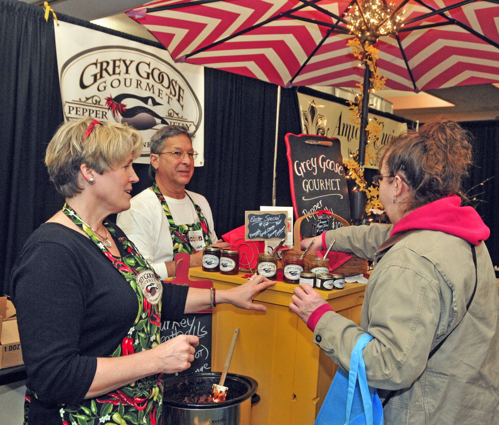 Sandra Dwight-Barnes, left, and Norman Barris talk to Jeanne Grimes about their Grey Goose Gourmet Pepper Jellies on Saturday at the Kennebec Valley Community College and 107.9 Mix Maine Culinary Festival in the Augusta Civic Center. Dwight-Barnes said she started her company one year ago with a recipe that came from her mother.
