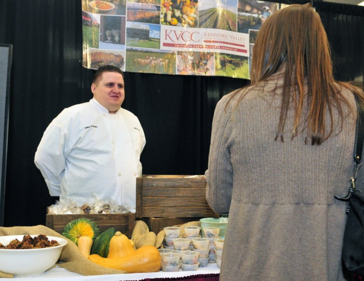 Kennebec Valley Community College culinary student Mike O’Brien chats with a showgoer Saturday at the college’s booth at the Kennebec Valley Community College and 107.9 Mix Maine Culinary Festival in the Augusta Civic Center.