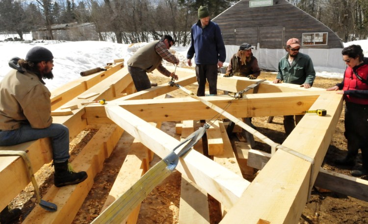 A king post truss is under construction at a farm in Troy that will be installed in the Troy Union Church once funds have been raised. Both local volunteers and members of the Preservation Timber Framing organization worked Tuesday, March 31, 2015. From left are Scott Pfeiffer, Scott Lewis, Marvin Daugherty, Adam Joy, Lee Hoagland and Jessica Milneil. 