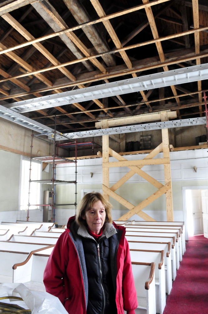 Norma Rossel, project coordinator for the Troy Union Church restoration project, speaks inside the church about the ongoing work. 