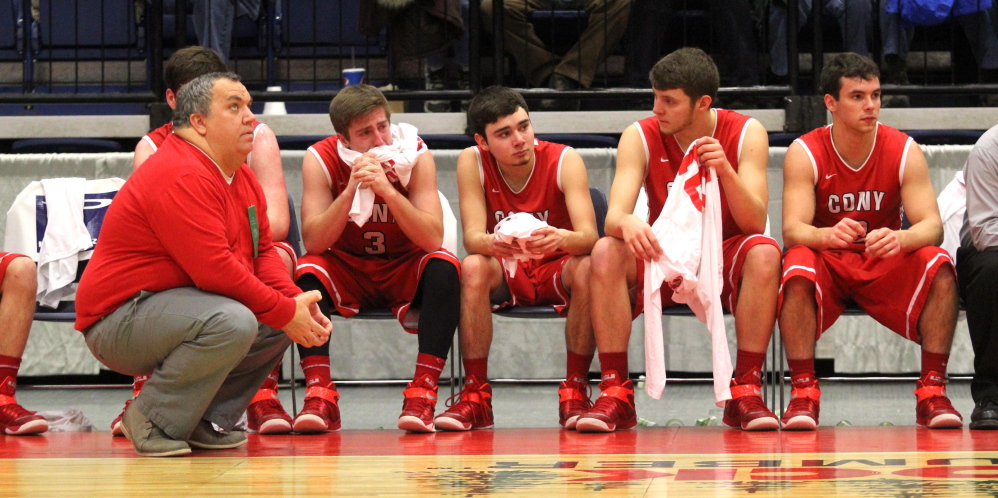 Cony High School coach T.J. Maines and his players react during the waning minutes of an 89-51 loss to Lewiston in an Eastern A quarterfinal at the Augusta Civic Center. For leading the Rams back to the playoffs, Maines has been named the 2014-15 Kennebec Journal Boys Basketball Coach of the Year.