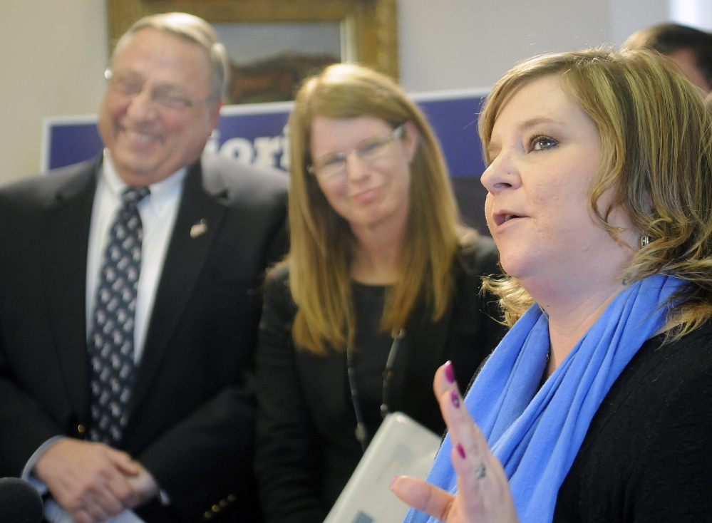 Former Temporary Assistance for Needy Families recipient Jill Rothrock expresses support for reforming the program with Gov. Paul LePage and Mary Mayhew, commissioner of the Department of Health and Human Services, at a press conference Monday in Augusta. Rothrock now works at DHHS.