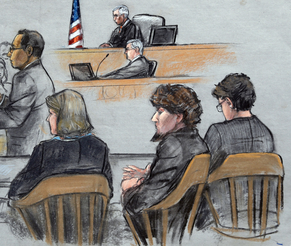 In this courtroom sketch, Assistant U.S. Attorney Aloke Chakravarty, left, is depicted addressing the jury as defendant Dzhokhar Tsarnaev, second from right, sits between his defense attorneys during closing arguments in Tsarnaev’s federal death penalty trial Monday, in Boston.