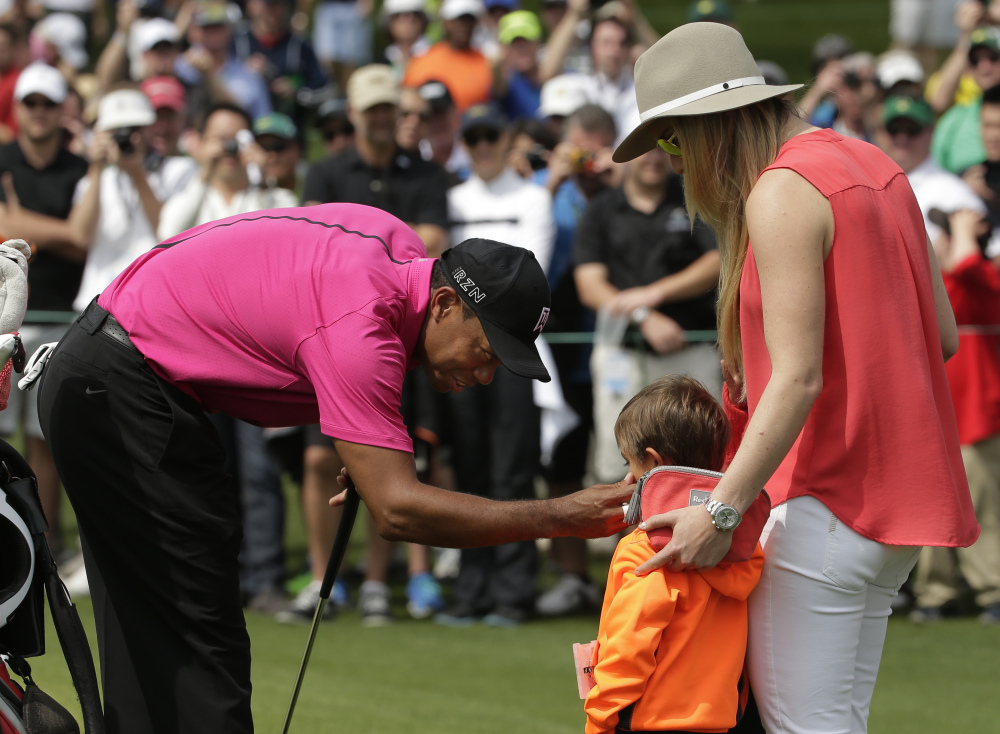 Lindsey Vonn watches as Tiger Woods speaks to his son Charlie during a practice round for the Masters golf tournament Tuesday in Augusta, Ga.