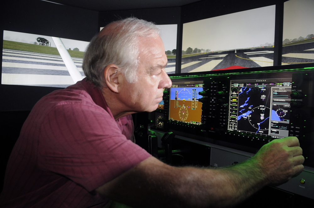 University of Maine at Augusta aviation program coordinator Greg Jolda adjusts instruments on the school’s flight simulator in this 2014 file photo.