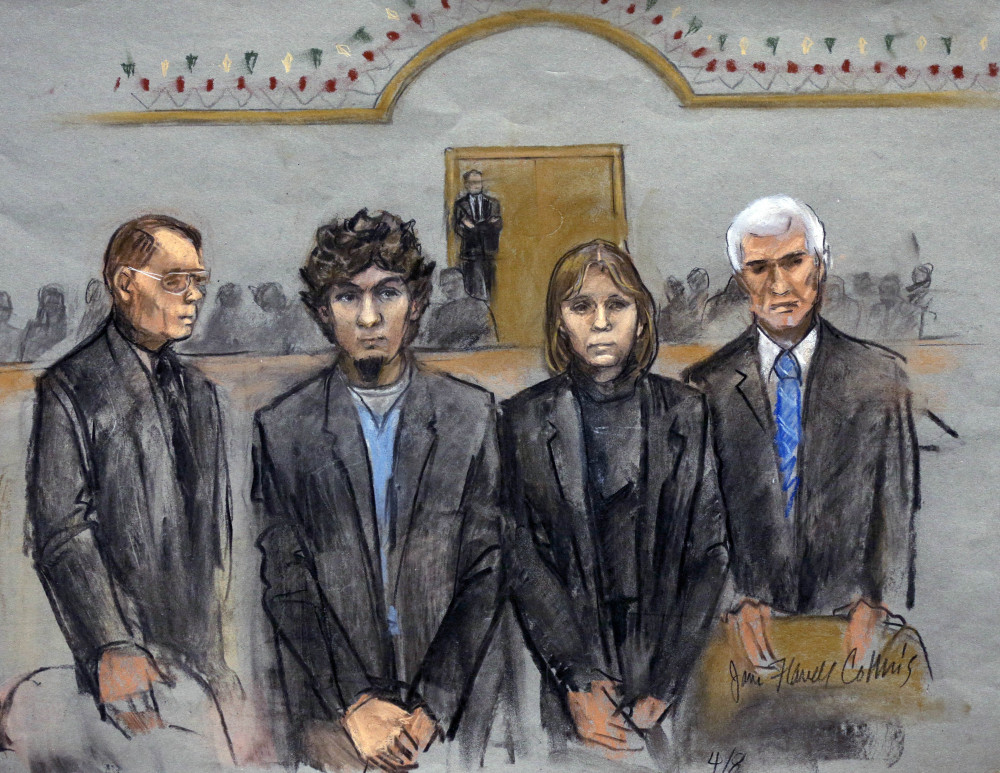 In this courtroom sketch, Dzhokhar Tsarnaev, second from left, stands with defense attorneys William Fick, left, Judy Clarke and David Bruck as the jury announces its verdict Wednesday. Tsarnaev was convicted on all 30 counts against him, 17 of which could carry the death penalty.